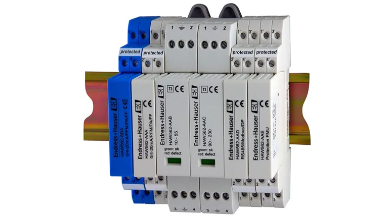 A photo of a group of electrical switches sitting on top of each other on a white background. The switches are protected by a clear plastic cover, and there is a label on the front of the cover that says "Endress+Hauser".